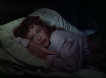 Movie still from “Unconquered” (1947), directed by Cecil B. DeMille – A woman laying in a bed under a blanket; Close Up shot, Overhead angle