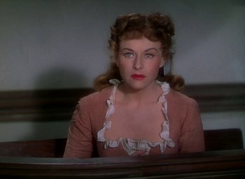 Movie still from “Unconquered” (1947), directed by Cecil B. DeMille – A woman sitting at a table in front of a window; Close Up shot, High angle