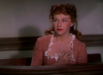 Movie still from “Unconquered” (1947), directed by Cecil B. DeMille – A woman sitting in front of a mirror in front of a wall; Close Up shot, Over the shoulder angle