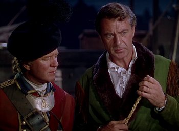 Movie still from “Unconquered” (1947), directed by Cecil B. DeMille – A man and a woman standing next to each other; Medium shot, Over the shoulder angle