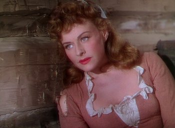 Movie still from “Unconquered” (1947), directed by Cecil B. DeMille – A woman in a pink shirt and a bow in her hair; Close Up shot, High angle