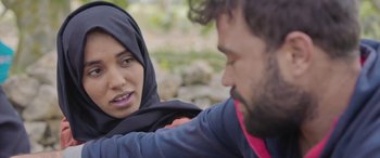 Movie still from “Under the Fig Trees” (2021), directed by Erige Sehiri – A man and a woman are looking at each other; Close Up shot, Over the shoulder angle