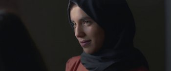 Movie still from “Under the Fig Trees” (2021), directed by Erige Sehiri – A person wearing a headscarf; Close Up shot, Low angle