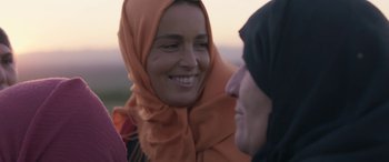 Movie still from “Under the Fig Trees” (2021), directed by Erige Sehiri – Two women wearing headscarfs talking to each other; Close Up shot, Over the shoulder angle