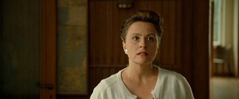 Movie still from “Under the Sun” (1998), directed by Colin Nutley – A person wearing a white shirt; Close Up shot, Low angle