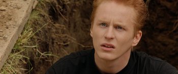 Movie still from “Under the Sun” (1998), directed by Colin Nutley – A person with red hair and blue eyes; Close Up shot, High angle