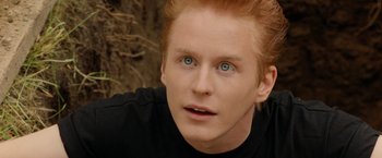 Movie still from “Under the Sun” (1998), directed by Colin Nutley – A person with red hair and blue eyes; Close Up shot, High angle