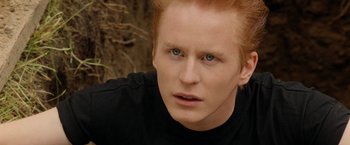 Movie still from “Under the Sun” (1998), directed by Colin Nutley – A person with red hair and blue eyes; Close Up shot, High angle