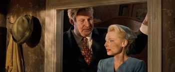 Movie still from “Under the Sun” (1998), directed by Colin Nutley – A man and a woman looking at each other in front of a mirror; Medium shot, Over the shoulder angle