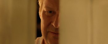 Movie still from “Under the Sun” (1998), directed by Colin Nutley – A man's face looking at the camera; Extreme Close Up shot, Over the shoulder angle