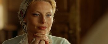 Movie still from “Under the Sun” (1998), directed by Colin Nutley – A person sitting with her hands clasped together; Close Up shot, Over the shoulder angle