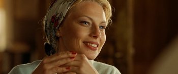 Movie still from “Under the Sun” (1998), directed by Colin Nutley – A beautiful woman with blue eyes wearing a head scarf; Close Up shot, Over the shoulder angle