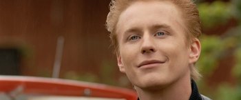 Movie still from “Under the Sun” (1998), directed by Colin Nutley – A person with blond hair and blue eyes; Close Up shot, Low angle