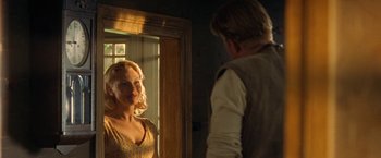 Movie still from “Under the Sun” (1998), directed by Colin Nutley – A man and a woman looking at each other in a mirror; Medium shot, Over the shoulder angle