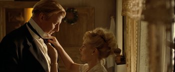 Movie still from “Under the Sun” (1998), directed by Colin Nutley – A woman putting a headband on another woman's head; Close Up shot, Over the shoulder angle