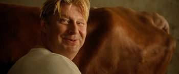 Movie still from “Under the Sun” (1998), directed by Colin Nutley – A person with blond hair; Close Up shot, Over the shoulder angle