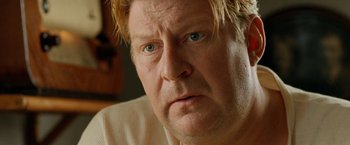 Movie still from “Under the Sun” (1998), directed by Colin Nutley – A man with blonde hair and blue eyes; Close Up shot, Low angle