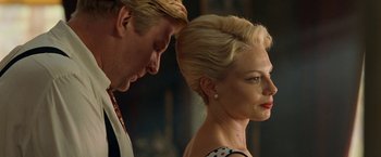 Movie still from “Under the Sun” (1998), directed by Colin Nutley – A man and a woman standing next to each other; Close Up shot, Low angle