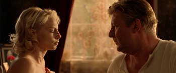 Movie still from “Under the Sun” (1998), directed by Colin Nutley – A man and a woman face to face in front of a window; Close Up shot, Over the shoulder angle