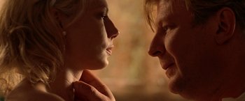 Movie still from “Under the Sun” (1998), directed by Colin Nutley – A woman and a man face to face in the sunlight; Close Up shot, Low angle