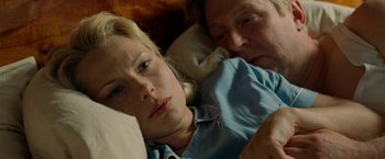 Movie still from “Under the Sun” (1998), directed by Colin Nutley – A man and a woman laying in bed together; Close Up shot, Over the shoulder angle