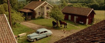 Movie still from “Under the Sun” (1998), directed by Colin Nutley – Two horses standing next to each other on a field; Extreme Wide shot, High angle