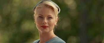 Movie still from “Under the Sun” (1998), directed by Colin Nutley – A woman with blonde hair wearing a hat; Close Up shot, Low angle