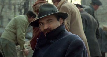 Movie still from “Underground” (1995), directed by Emir Kusturica – A person wearing a hat; Close Up shot, Low angle