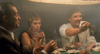 Movie still from “Underground” (1995), directed by Emir Kusturica – A man and a woman sitting at a dinner table; Medium shot, Low angle