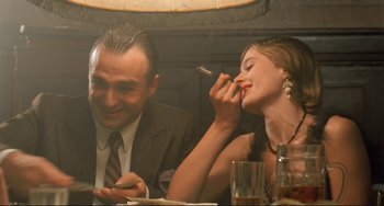 Movie still from “Underground” (1995), directed by Emir Kusturica – A man and a woman sitting at a dinner table; Medium shot, Low angle