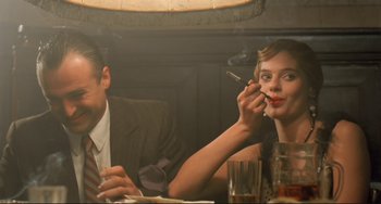 Movie still from “Underground” (1995), directed by Emir Kusturica – A man and a woman sitting at a dinner table; Close Up shot, Low angle