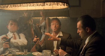 Movie still from “Underground” (1995), directed by Emir Kusturica – A group of people sitting around a table; Medium shot, Low angle