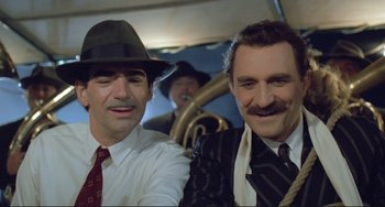 Movie still from “Underground” (1995), directed by Emir Kusturica – A couple of men standing next to each other; Close Up shot, Low angle