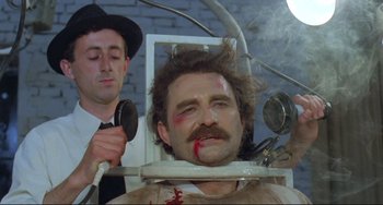 Movie still from “Underground” (1995), directed by Emir Kusturica – A man with a beard and a mustache in a dentist's chair; Close Up shot, High angle