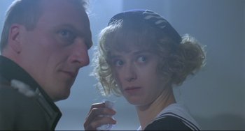 Movie still from “Underground” (1995), directed by Emir Kusturica – A man and a woman looking at each other; Close Up shot, Low angle