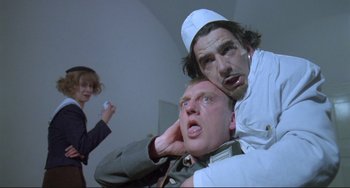 Movie still from “Underground” (1995), directed by Emir Kusturica – Two men and a woman in a room; Medium shot, Low angle