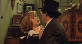 Movie still from “Underground” (1995), directed by Emir Kusturica – A man and a woman are kissing in a living room; Close Up shot, Over the shoulder angle