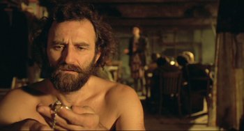 Movie still from “Underground” (1995), directed by Emir Kusturica – A man with a beard is holding a cigarette in his mouth; Close Up shot, Low angle