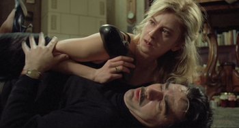 Movie still from “Underground” (1995), directed by Emir Kusturica – A man and a woman are laying on the floor; Close Up shot, High angle