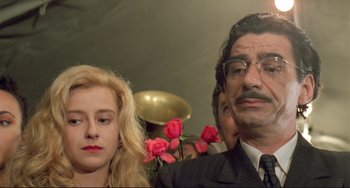 Movie still from “Underground” (1995), directed by Emir Kusturica – A man and a woman with roses in front of them; Close Up shot, Low angle