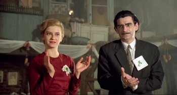 Movie still from “Underground” (1995), directed by Emir Kusturica – A man and a woman standing next to each other in a room; Medium shot, Low angle