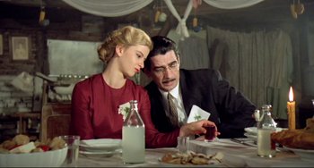 Movie still from “Underground” (1995), directed by Emir Kusturica – A man and a woman sitting at a dinner table; Medium shot, Low angle