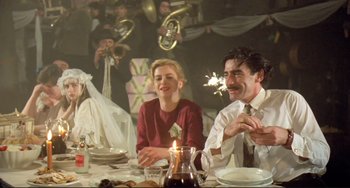 Movie still from “Underground” (1995), directed by Emir Kusturica – A group of people sitting around a table; Medium shot, Low angle