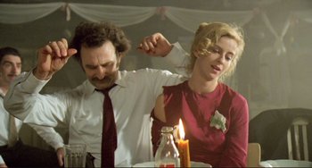 Movie still from “Underground” (1995), directed by Emir Kusturica – A man and a woman sitting at a dinner table; Medium shot, Low angle