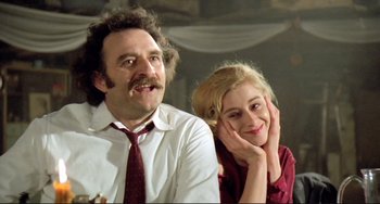 Movie still from “Underground” (1995), directed by Emir Kusturica – A man and a woman sitting next to each other; Close Up shot, Low angle