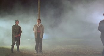 Movie still from “Underground” (1995), directed by Emir Kusturica – A man standing in the middle of a foggy field; Wide shot, Low angle
