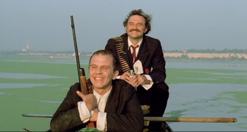 Movie still from “Underground” (1995), directed by Emir Kusturica – Two men sitting on a boat in the middle of a lake; Close Up shot, Low angle