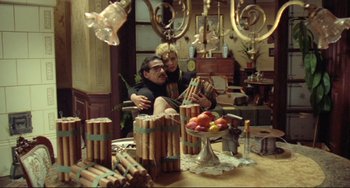 Movie still from “Underground” (1995), directed by Emir Kusturica – A man and a woman sitting at a dining table; Wide shot, High angle