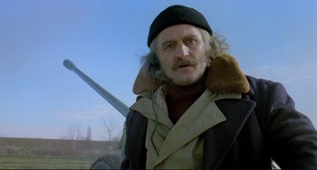 Movie still from “Underground” (1995), directed by Emir Kusturica – An older man wearing a hat and a jacket; Close Up shot, Low angle