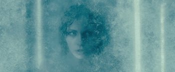 Movie still from “Underworld: Awakening” (2012), directed by Björn Stein – A woman's face in the middle of a cloud of water; Close Up shot, Overhead angle